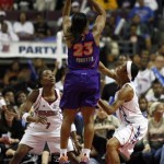 Phoenix Mercury forward Cappie Pondexter (23) shoots over the defense of Detroit Shock guard Shannon Johnson (7) and Deanna Nolan during the second quarter of the WNBA Finals at the Palace of Auburn Hills, Mich., Sunday, Sept. 16, 2007. (AP Photo/Gary Malerba)