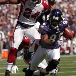 Baltimore Ravens wide receiver Derrick Mason, right, runs past the defense of Arizona Cardinals safety Adrian Wilson during the second quarter Sunday. Mason scored a touchdown on the play. AP Photo/Steve Ruark