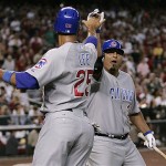 Chicago Cubs' Derek Lee gets a high five from teammate Carlos Zambrano after Lee scored a run against the Arizona Diamondbacks in the sixth inning in Game 1. AP Photo/Ross D. Franklin