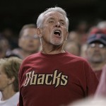 An Arizona Diamondbacks fan yells at a call during the seventh inning in Game 1 of the National League Championship baseball series against the Colorado Rockies in Phoenix, Thursday. Play was halted after fans threw debris on the field. (AP Photo/David J. Phillip)