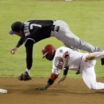 Arizona Diamondbacks' Justin Upton takes out Colorado Rockies second baseman Kazuo Matsui (7) during the seventh inning in Game 1 of the National League Championship baseball series in Phoenix, Thursday. Upton was called for interference on the play. (AP Photo/Eric Gay)