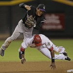 Arizona Diamondbacks' Justin Upton, bottom, is called for interference as he takes out Colorado Rockies second baseman Kazuo Matsui, top, during the seventh inning in Game 1 of the National League Championship baseball series in Phoenix, Thursday. (AP Photo/David J. Phillip)