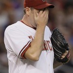 Arizona Diamondbacks starter Brandon Webb wipes his face after giving up a run during the second inning in Game 1 of the National League Championship baseball series against the Colorado Rockies in Phoenix, Thursday. (AP Photo/David J. Phillip)