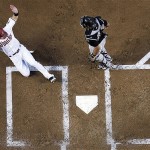 Arizona Diamondbacks' Stephen Drew, left, slides home safely in front of Colorado Rockies catcher Yorvit Torrealba during the first inning in Game 1 of the National League Championship baseball series in Phoenix. Drew scored from first on a RBI double by Eric Byrnes. (AP Photo/David J. Phillip)