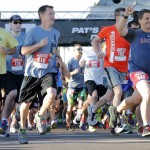 Runners, one wearing a Boston Red Sox shirt, compete in the 9th annual Pat's Run, Saturday, April 20, 2013, in Tempe, Ariz. Pat's Run is a celebration of the life of Pat Tillman, the NFL star who walked away from millions of dollars to become and Army Ranger after the Sept. 11 terrorist attacks. The 4.2-mile run through the streets of Tempe takes on added significance following the bombings at the Boston Marathon. (AP Photo/Matt York)