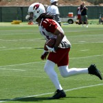 Receiver Larry Fitzgerald runs with the ball during Arizona Cardinals OTAs on Tuesday, May 14 at the team's Tempe training facility. (Adam Green/Arizona Sports)