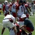 Larry Fitzgerald checks on injured receiver LaRon Byrd during Arizona Cardinals OTAs on Tuesday, May 14 at the team's Tempe training facility. Byrd suffered a neck spasm. (Adam Green/Arizona Sports)