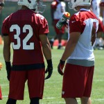 Safety Tyrann Mathieu (left) and kicker Jay Feely share a word during OTAs on May 21, 2013 at the team's Tempe training facility. (Adam Green/Arizona Sports)
