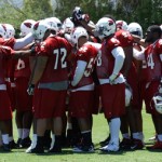 Cardinals defenders huddle up during OTAs on May 21, 2013 at the team's Tempe training facility. (Adam Green/Arizona Sports)
