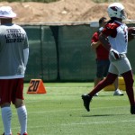 Head coach Bruce Arians watches as receiver Larry Fitzgerald runs by during Arizona Cardinals OTAs at their Tempe training facility on Monday, June 3. (Adam Green/Arizona Sports)