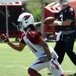 Receiver Larry Fitzgerald begins his route while quarterback Carson Palmer receives the snap during Arizona Cardinals OTAs on Thursday, June 6, 2013. (Adam Green/Arizona Sports)
