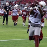 Quarterback Carson Palmer watches as receiver Larry Fitzgerald comes down with the catch during Arizona Cardinals Fan Fest at University of Phoenix Stadium on June 11, 2013. (Adam Green/Arizona Sports)