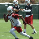Receiver Larry Fitzgerald begins his route during minicamp on Wednesday, June 12, at the team's Tempe training facility. (Adam Green/Arizona Sports)