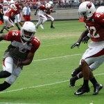 Andre Roberts turns the corner ahead of defensive back Bryan McCann during the Cardinals' Red & White Practice Saturday, August 3 at University of Phoenix Stadium in Glendale. (Adam Green/Arizona Sports)