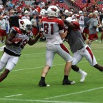 Running back Alfonso Smith turns the corner while Jim Dray blocks during the Cardinals' Red & White Practice Saturday, August 3 at University of Phoenix Stadium in Glendale. (Adam Green/Arizona Sports)
