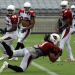 Receiver Larry Fitzgerald dives into the end zone during Arizona Cardinals training camp Monday, Aug. 12, at University of Phoenix Stadium in Glendale. (Adam Green/Arizona Sports)