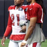 Defensive back Patrick Peterson chats with receiver Larry Fitzgerald during Arizona Cardinals training camp Tuesday, Aug. 13 at University of Phoenix Stadium in Glendale. (Adam Green/Arizona Sports)