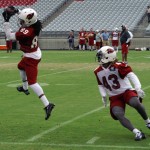 Receiver Charles Hawkins leaps to make a catch in front of Ronnie Yell during Arizona Cardinals training camp on Aug. 19, 2013 at University of Phoenix Stadium in Glendale. (Adam Green/Arizona Sports)