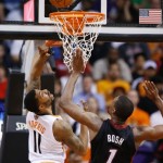 Phoenix Suns' Markieff Morris (11) has his shot altered by Miami Heat's Chris Bosh (1) during the first half of an NBA basketball game Tuesday, Feb. 11, 2014, in Phoenix. (AP Photo/Ross D. Franklin)