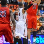 Arizona's Nick Johnson (13) shoots against Oregon State's Hallice Cooke (3) during the first half of an NCAA college basketball game in Corvallis, Ore., Wednesday March 5, 2014. (AP Photo/Greg Wahl-Stephens)