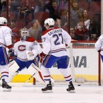 Montreal Canadiens' Peter Budaj (30), of the Czech Republic, gives up an early goal to Phoenix Coyotes' Radim Vrbata as Canadiens' Douglas Murray (6), of Sweden, Alex Galchenyuk (27), and Mike Weaver (43) all look for the puck during the first period of an NHL hockey game on Thursday, March 6, 2014, in Glendale, Ariz. (AP Photo/Ross D. Franklin)
