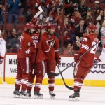 Montreal Canadiens' Alex Galchenyuk (27) and Rene Bourque (17) skate away from the celebration of Phoenix Coyotes' Radim Vrbata, third from left, of the Czech Republic, as he is congratulated for his goal by teammates David Schlemko (6), Michael Stone (26) and Kyle Chipchura during the first period of an NHL hockey game on Thursday, March 6, 2014, in Glendale, Ariz. (AP Photo/Ross D. Franklin)