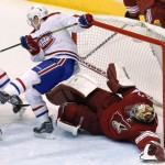 Montreal Canadiens' Brendan Gallagher, left, collides with Phoenix Coyotes' Mike Smith during the third period of an NHL hockey game Thursday, March 6, 2014, in Glendale, Ariz. The Coyotes defeated the Canadiens 5-2. (AP Photo/Ross D. Franklin)