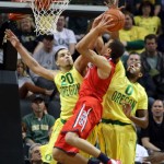 Oregon's Waverly Austin, left, fouls Arizona's Aaron Gardon as he defends the basket with teammate Oregon's Mike Moser, right, during the first half of an NCAA college basketball game in Eugene, Ore. on Saturday, March 8, 2014. (AP Photo/Chris Pietsch)