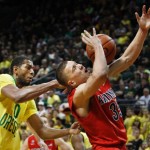 Oregon's Mike Moser, left, pressures Arizona's Kaleb Tarczewski into turning over the ball under the basket during the second half of an NCAA college basketball game in Eugene, Ore. on Saturday, March 8, 2014. (AP Photo/Chris Pietsch)