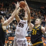 Oregon State's Roberto Nelson, shoots over Arizona State's Jordan Bachynski, left and Jonathon Gilling, right, during the second half of an NCAA college basketball game in Corvallis, Ore., Saturday March 8 2014. Oregon State won the game 78-76.(AP Photo/Karl Maasdam)