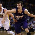 Phoenix Suns' Goran Dragic, right, drives the ball past Golden State Warriors' Stephen Curry (30) during the first half of an NBA basketball game Sunday, March 9, 2014, in Oakland, Calif. (AP Photo/Ben Margot)