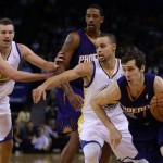 Phoenix Suns' Goran Dragic, right, drives past Golden State Warriors' Stephen Curry, second from right, during the first half of an NBA basketball game Sunday, March 9, 2014, in Oakland, Calif. (AP Photo/Ben Margot)
