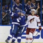Tampa Bay Lightning center Tyler Johnson (9) celebrates his goal against the Phoenix Coyotes with teammate Ondrej Palat (18), of the Czech Republic, during the first period of an NHL hockey game, Monday, March 10, 2014, in Tampa, Fla. Skating off is Coyotes' Michael Stone (26). (AP Photo/Chris O'Meara)