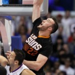 Phoenix Suns center Miles Plumlee (22) pulls down a pass over Los Angeles Clippers forward Hedo Turkoglu, left, of Turkey during the first half of an NBA basketball game Monday, March 10, 2014, in Los Angeles. (AP Photo/Alex Gallardo)