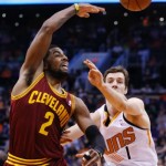 Cleveland Cavaliers' Kyrie Irving (2) gets off a pass over Phoenix Suns' Goran Dragic (1), of Slovenia, during the first half of an NBA basketball game on Wednesday, March 12, 2014, in Phoenix. (AP Photo/Ross D. Franklin)