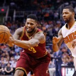 Cleveland Cavaliers' Alonzo Gee, left, loses the ball as it is tipped away by Phoenix Suns' Marcus Morris, right, during the first half of an NBA basketball game on Wednesday, March 12, 2014, in Phoenix. (AP Photo/Ross D. Franklin)