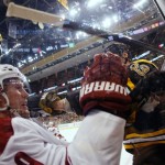 In this photo taken with a fish eye lens, Phoenix Coyotes' Shane Doan loses his stick after being hit by Boston Bruins defenseman Zdeno Chara during the second period of an NHL hockey game in Boston Thursday, March 13, 2014. (AP Photo/Winslow Townson)