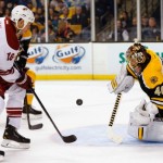 Boston Bruins goalie Tuukka Rask of Finland makes a save as Phoenix Coyotes' David Moss (18) looks for the rebound during the third period of Boston's 2-1 win in an NHL hockey game in Boston Thursday, March 13, 2014. (AP Photo/Winslow Townson)