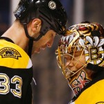 Boston Bruins goalie Tuukka Rask of Finland is congratulated by defenseman Zdeno Chara (33) of Slovakia after their 2-1 win over the Phoenix Coyotes in an NHL hockey game in Boston Thursday, March 13, 2014. (AP Photo/Winslow Townson)