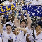 UCLA players celebrate with the championship trophy after beating Arizona 75-71 in the championship game of the NCAA Pac-12 conference college basketball tournament, Saturday, March 15, 2014, in Las Vegas. (AP Photo/Julie Jacobson)