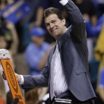 UCLA coach Steve Alford holds up a piece of the net after his team defeated Arizona, 75-71, in the championship game of the NCAA Pac-12 conference college basketball tournament, Saturday, March 15, 2014, in Las Vegas. (AP Photo/Julie Jacobson)