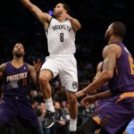 Brooklyn Nets's Deron Williams makes a basket during the first half of the NBA basketball game against the Phoenix Suns at the Barclays Center Monday, March 17, 2014 in New York. (AP Photo/Seth Wenig)