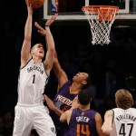 Brooklyn Nets's Mason Plumlee, left, puts up a shot over Phoenix Suns' Channing Frye, second form left, and Gerald Green (14) during the second half of the NBA basketball game at the Barclays Center Monday, March 17, 2014 in New York. The Nets defeated the Suns 108-95. (AP Photo/Seth Wenig)