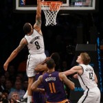 Brooklyn Nets's Deron Williams, top, dunks the ball during the second half of the NBA basketball game against the Phoenix Suns at the Barclays Center Monday, March 17, 2014 in New York. The Nets defeated the Suns 108-95. (AP Photo/Seth Wenig)