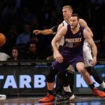 Brooklyn Nets' Mason Plumlee, left, knocks the ball away from Phoenix Suns' Miles Plumlee during the first half of the NBA basketball game at the Barclays Center Monday, March 17, 2014 in New York. (AP Photo/Seth Wenig)
