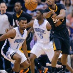 Phoenix Suns guard Ish Smith, right, passes as Orlando Magic guard Doron Lamb (1) defends during the first half of an NBA basketball game, Wednesday, March 19, 2014, in Phoenix. (AP Photo/Matt York)