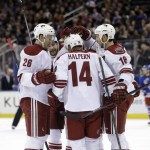 Phoenix Coyotes' Jeff Halpern (14) celebrates with teammates after scoring during the first period of the NHL hockey game against the New York Rangers, Monday, March 24, 2014, in New York. (AP Photo/Seth Wenig)