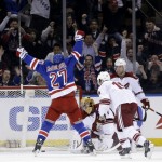 New York Rangers' Ryan McDonagh (27) reacts after scoring the winning goal in overtime at the NHL hockey game against the Phoenix Coyotes, Monday, March 24, 2014, in New York. The Rangers defeated the Coyotes in overtime 4-3. (AP Photo/Seth Wenig)