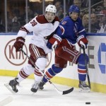 Phoenix Coyotes' Brandon McMillan, left, and New York Rangers' Anton Stralman look after the puck during the third period of the NHL hockey game, Monday, March 24, 2014, in New York. The Rangers defeated the Coyotes in overtime 4-3. (AP Photo/Seth Wenig)
