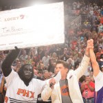 Tim Boven, right, is presented with a large check during a Phoenix Suns-New York Knicks game for making a halfcourt shot during a timeout in the game in Phoenix on Friday, March 28. (Photo courtesy of the Phoenix Suns)